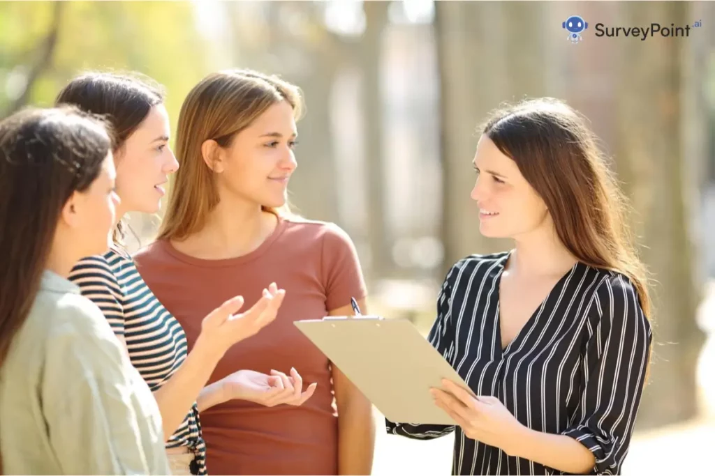 Four young women chatting in a park during a One Question Survey.