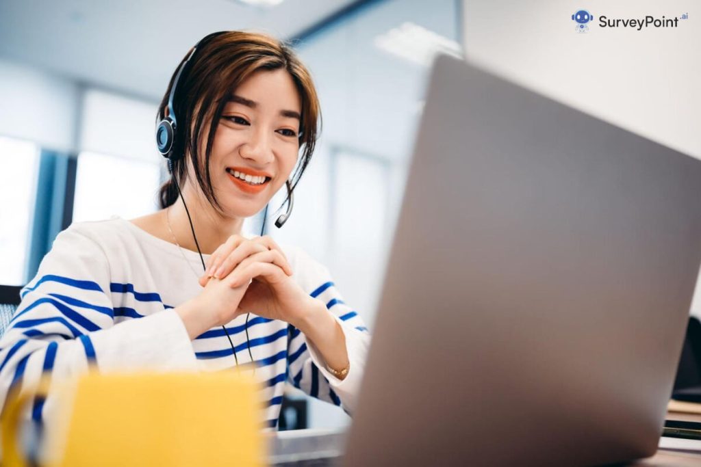 Woman in headset smiling, working on laptop for Paid Online Surveys.