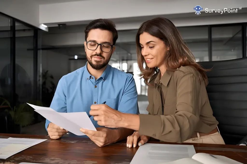 A man and woman reviewing Surveys On The Go Codes on paperwork.