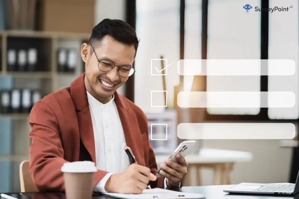 Asian businessman in office, using laptop and pen.