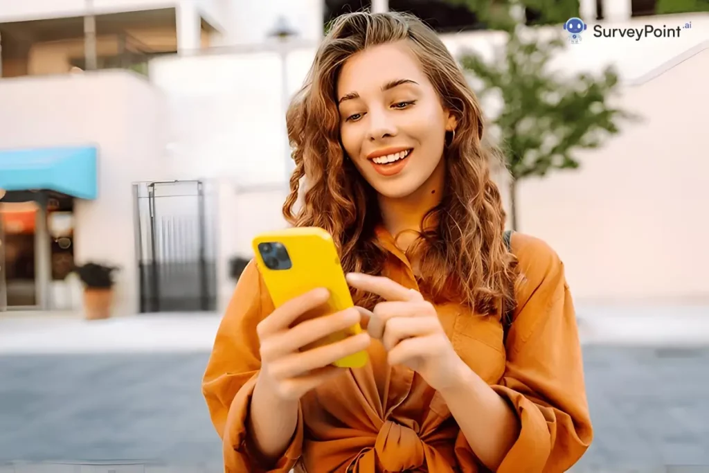 A woman happily holding a yellow phone, shaping the future of reading.