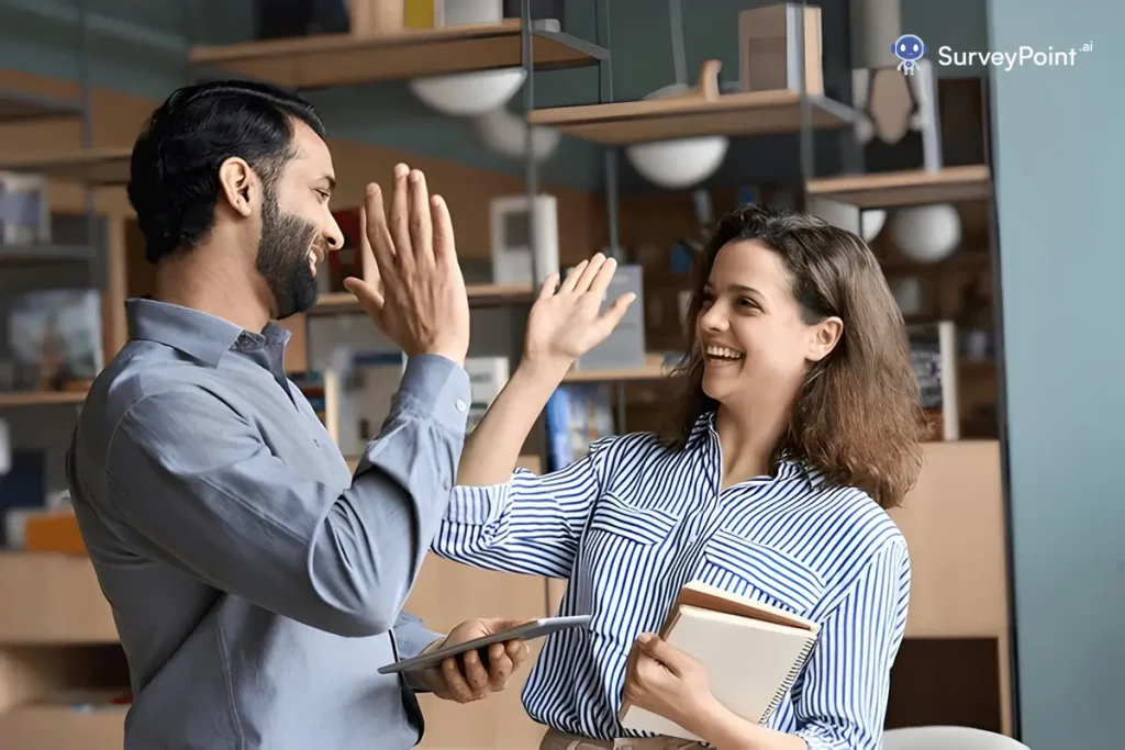 A man and woman joyfully exchange high fives, celebrating their positive experience with the Coca Cola Customer Service Survey.