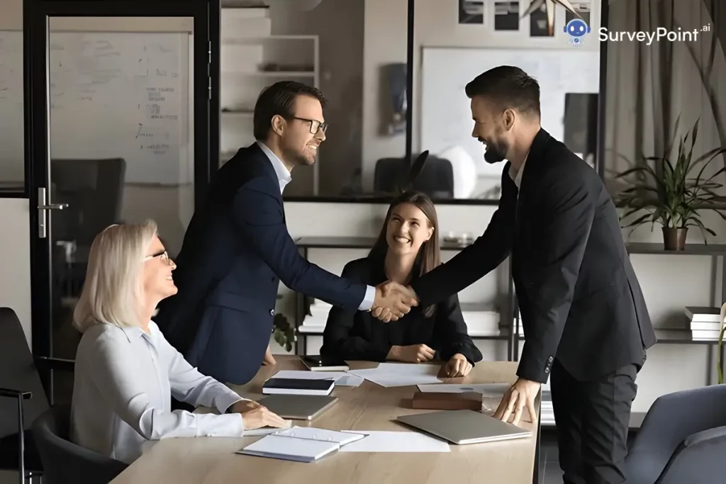 Three business individuals engaged in a handshake within an office setting, representing teamwork in employee engagement survey vendors.