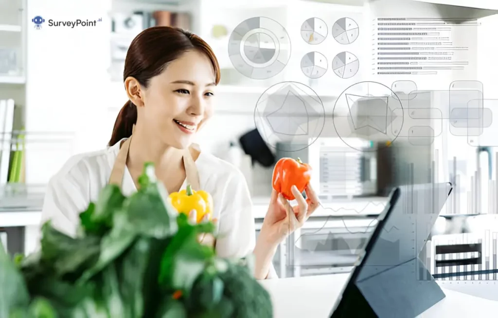 A woman holds a vegetable while gazing at a laptop, engaged in a cooking survey.