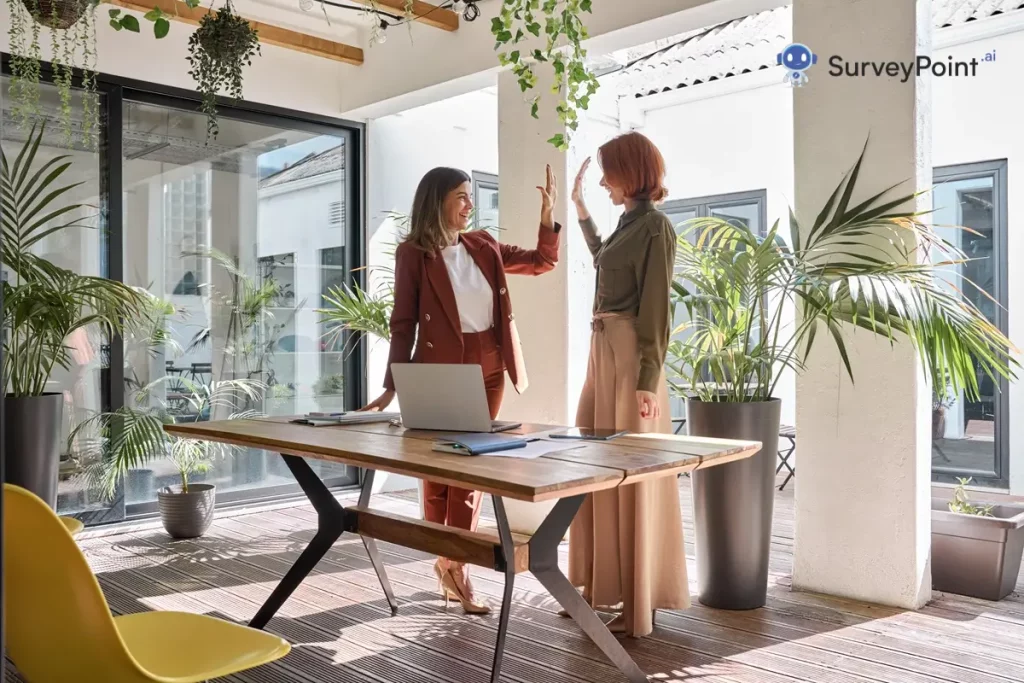 Two women collaborate at a table, analyzing data on a laptop for Expert Site Surveys.