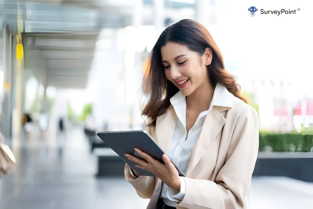 A professional woman in a business suit holds a tablet, representing the concept of Voice Surveys in a corporate setting.