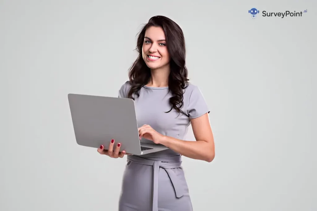 A professional woman in a business dress confidently holds a laptop, symbolizing Design Smarter Questionnaires.