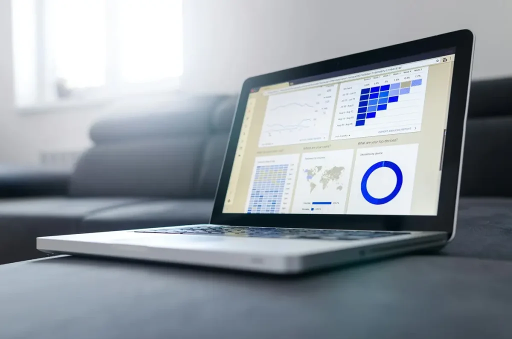 A laptop on a couch displays a graph, symbolizing innovative data collection methods in a modern setting.