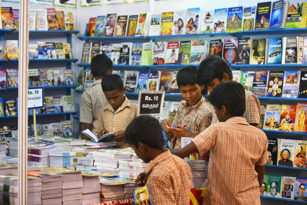 A group of children exploring books in a bookstore, showcasing their curiosity and enthusiasm for reading.