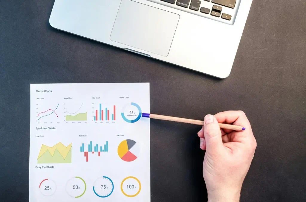 A hand of a businessman grips a pencil and paper filled with graphs, highlighting statistics related to an ice cream survey.